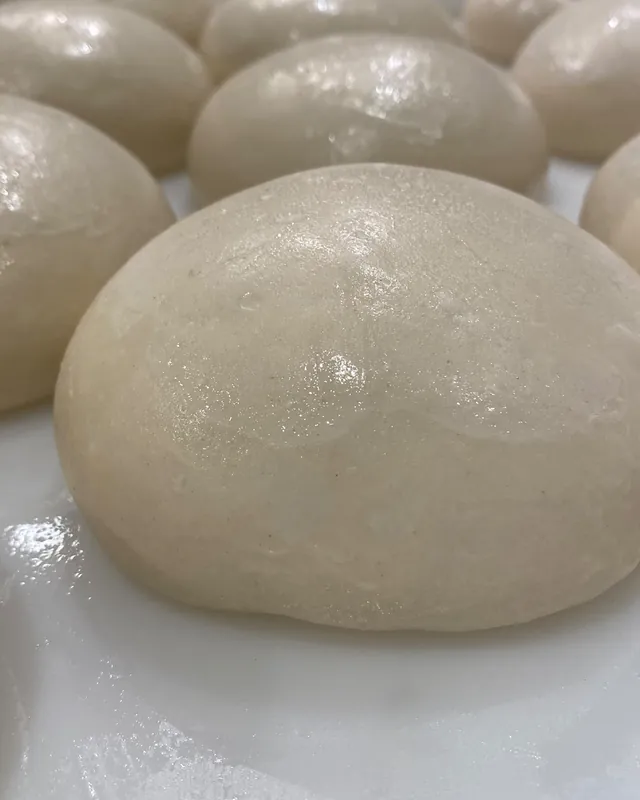 Bolas de masa reposando en la bandeja